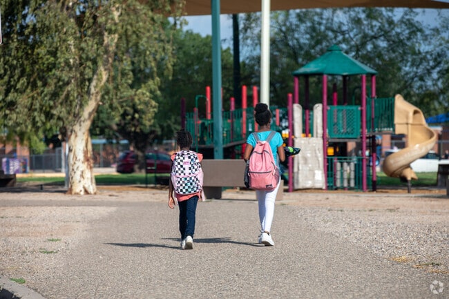 Children walk safely to school through the Vista del Prado park in Stella Mann.