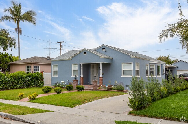 Choose a light blue stucco home with a brick walkway in Bell.