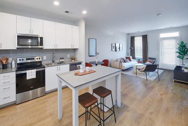 Design Collection II kitchen, living, and dining areas with hard surface flooring throughout