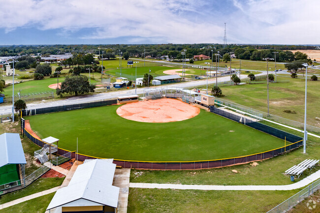 Students play softball on Eustis Heights Elementary School's plush field in Lake County.