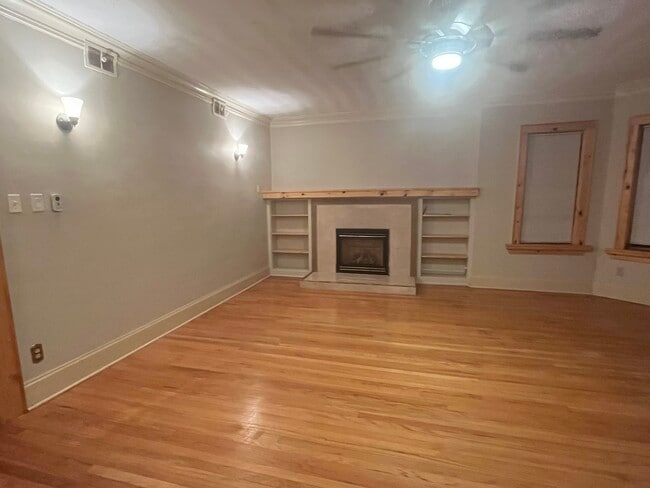 Gas burning fireplace with mantle and shelving.