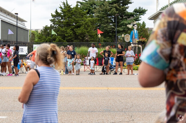 Residents of Lincoln Park line the streets awaiting the Twilight Parade to start the state fair.