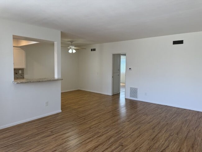 Apt #5: View from livingroom toward kitchen pass-thru window and hallway to bedrooms