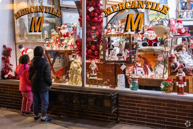 Two kids look at a Christmas window display during the Shop and Dine Fridays event.