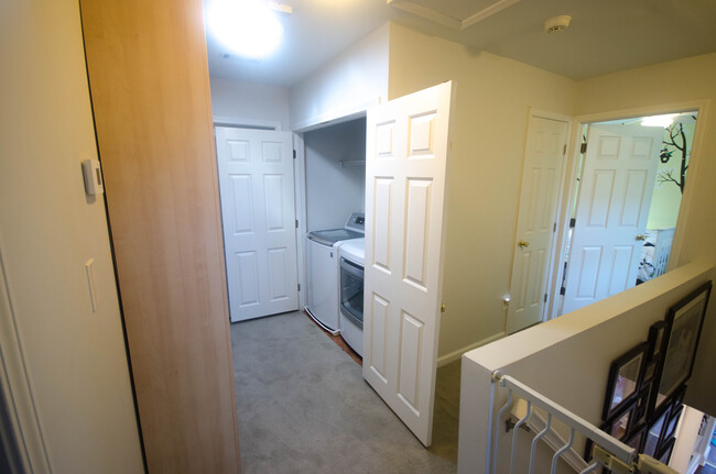 Upstairs hallway with large linen cabinet and laundry