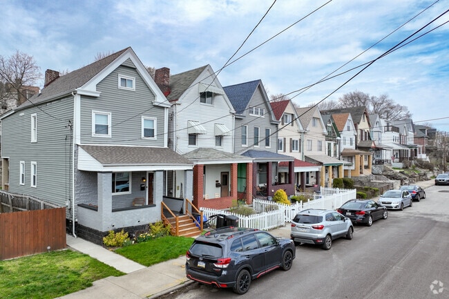 Gabled roof houses with porches line Broad Street.