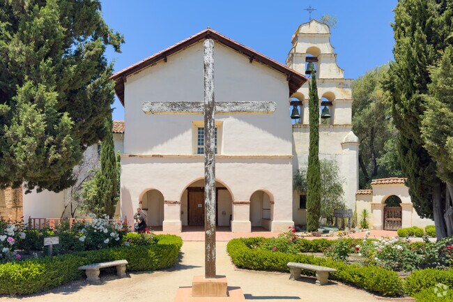 A cross stands in front at The Mission San Juan Bautista in San Juan Bautista, California.