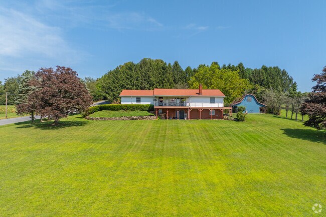 Ranch style homes in Muncy sit beneath rolling tree lines of shade.