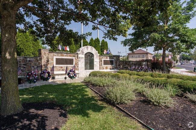 A memorial honoring those who served stands solemnly on a street corner in St. Davids.