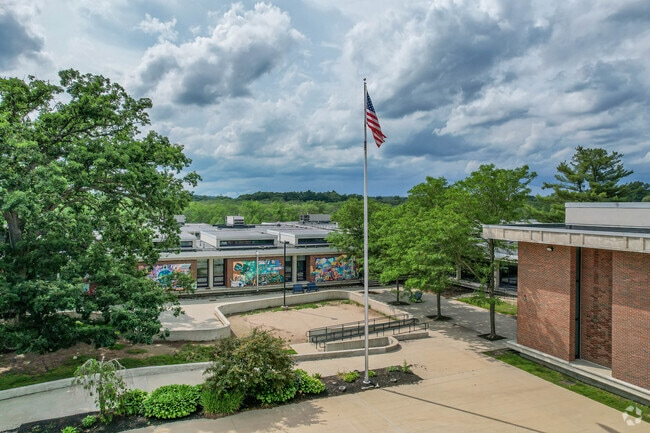 The Hillside Elementary School entrance in Needham has a flag in front of the building.