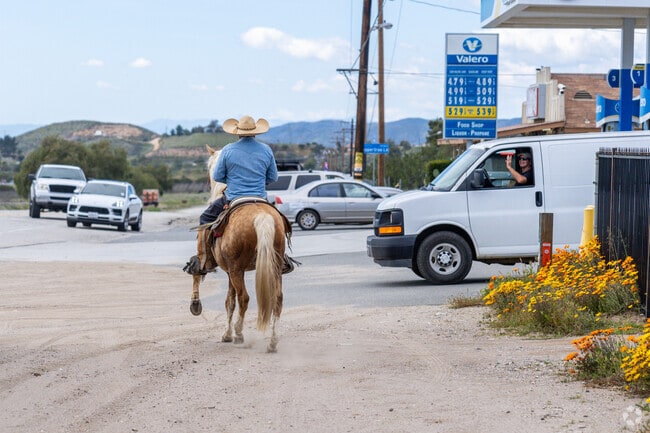 A man trots along Sierra Hwy on his horse in Agua Dulce.