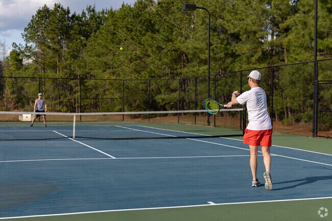Residents of Godley Station enjoy community activities such as tennis.
