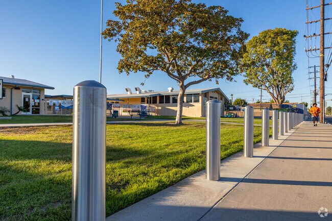 A pedestrian walks down the sidewalk next to Robert M. Pyles Elementary School.