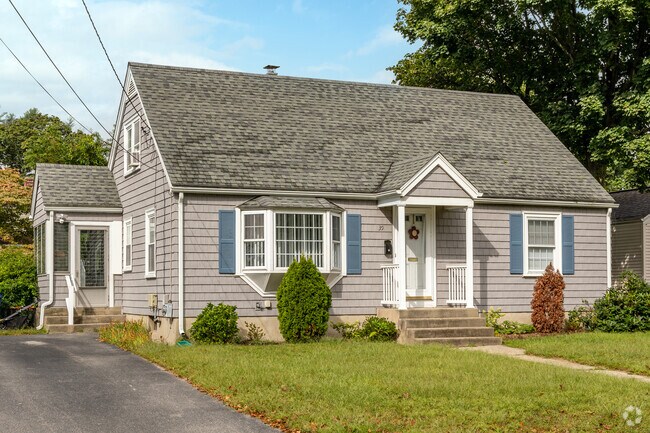 This classic mid-century cape style home has a gabled entry in the Buttonwoods neighborhood.