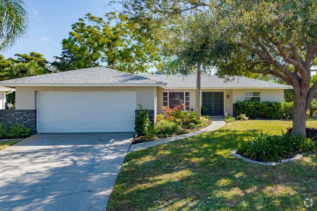 Single family homes in Jacaranda West offer manicured front lawns with two-car garages.