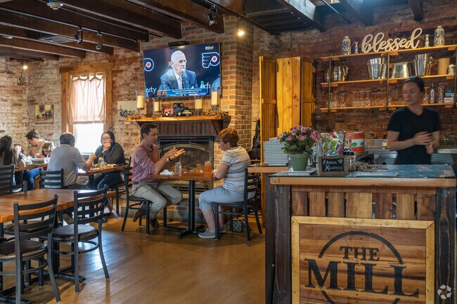 Residents gather in the upstairs dining room at The Mill in Kulpsville to enjoy pizza.