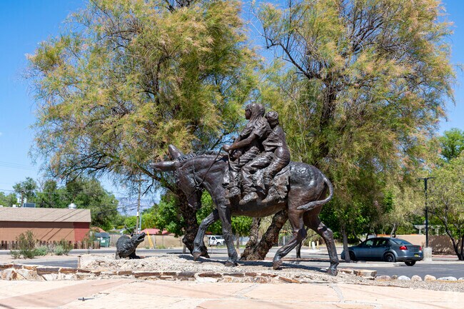 A statue depicting residents of Adobe Acres from over one hundred years ago.