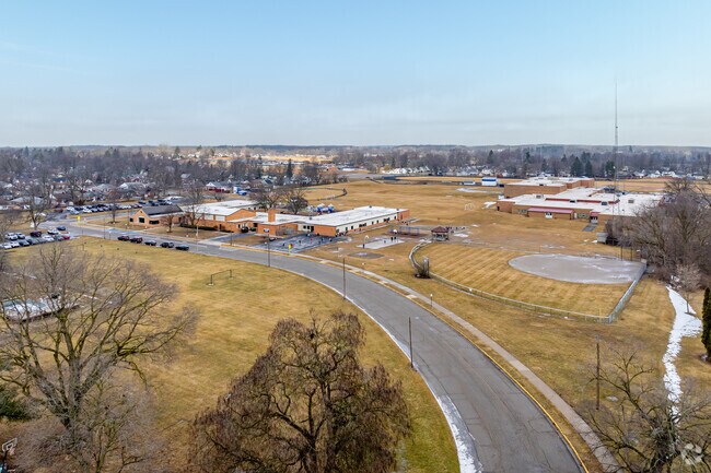 Alexander Elementary School features a large play area next to the school for student recess.