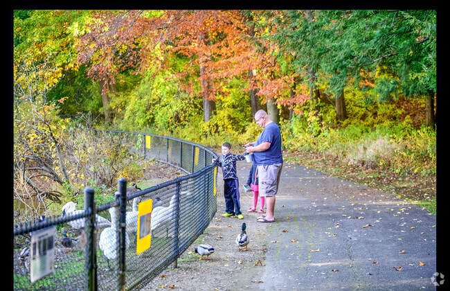 A family enjoys feeding the birds at  the Kellogg Bird Sanctuary near South Gull Lake.