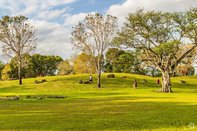 Kendale Lakes Park features rolling hills for outdoor play and exploration.