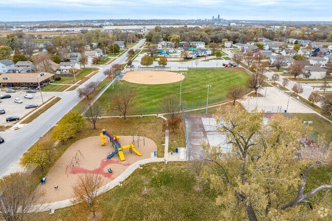 The many amenities of Sunset Park include a playground, aquatic center, and a horseshoe complex.