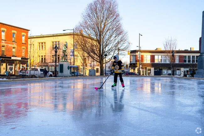 A kid practices his ice hockey moves on the public rink in the Leominster town square.