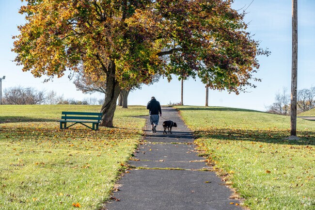 An East Fairmount resident walks his dog at Harmont Park.