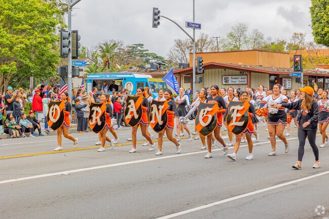 The Orange High School Cheer Team attends the Orange May Parade.