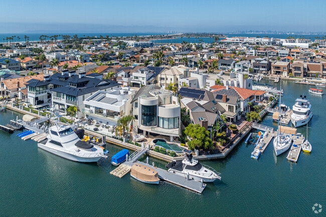 Waterfront mansions take advantage of their bay frontage with docks and watercraft.