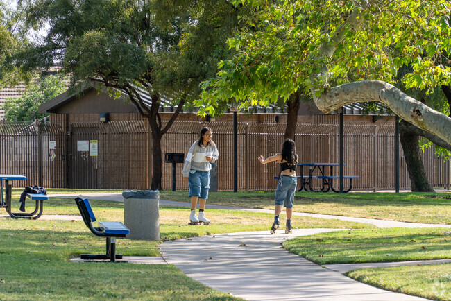 Serrano residents enjoy nearby John F. Kennedy Memorial Park, a recently refurbished community space featuring shaded playgrounds, lighted tennis courts, and a baseball field—perfect for family outings and recreational activities.