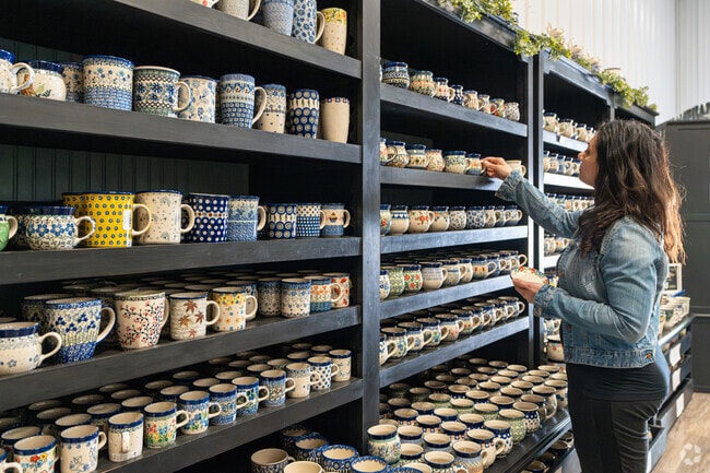 A woman shops for handmade coffee mugs at More Polish Pottery in Big Rock.