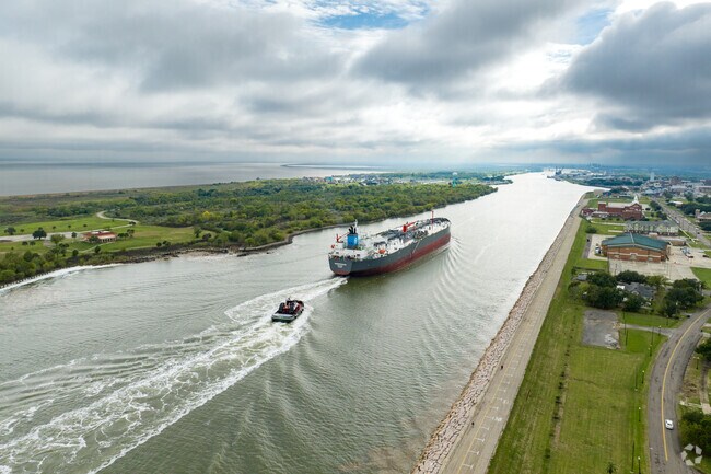 A large ship flowing through the channels of Port Arthur.