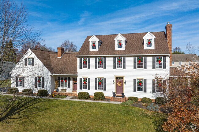 A massive Colonial home with dormer windows and a large yard in New Freedom.