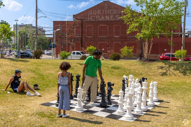 Play chess with family along the riverfront in Rivertown.