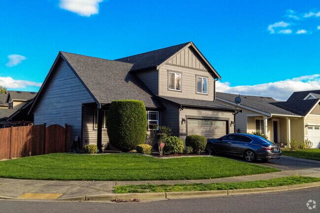 An immaculate home with a cross-gabled roof stands in the Pacific Neighborhood.
