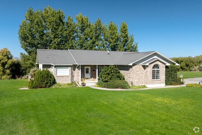 Ranch‑style homes are set back from the road with open views.