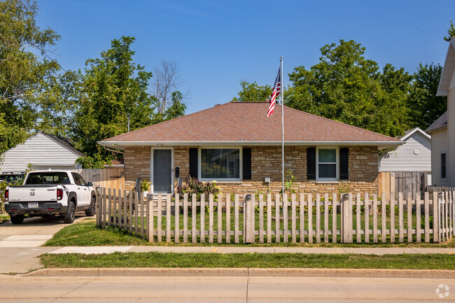 Located in Congress Field is a brick midcentury style home with fenced yard.