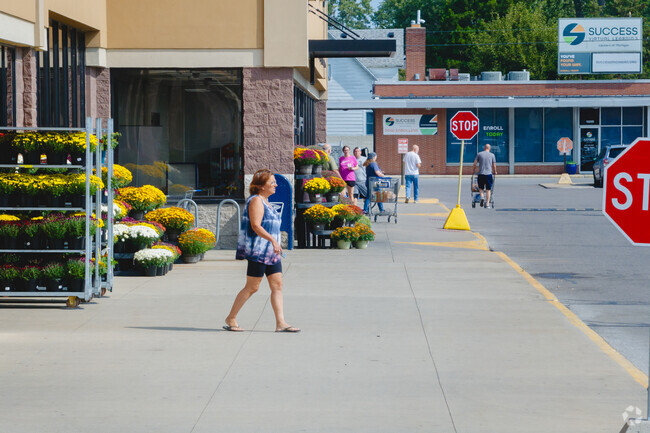 Residents line the sidewalks in the plaza where most do their shopping in West Monroe.
