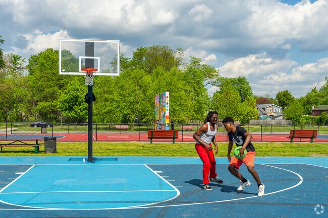 Friends gather at Von Nieda Park on the basketball courts for a pick up game.