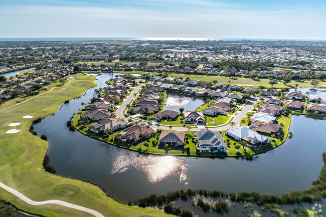 The Pelican Pointe community is surrounded by both lakes and lush green fairways.