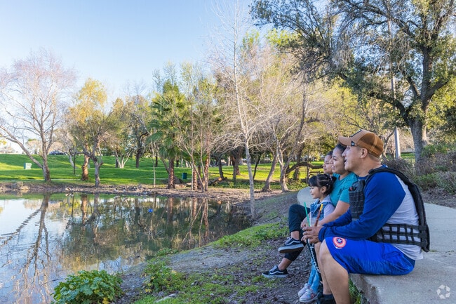 A family enjoying a lake day at Buchanan Park Playground in Meadowbrook.