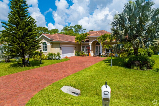 The red tile roofs of Spanish Revival homes contrasts green lawns in Sapphire Lakes.