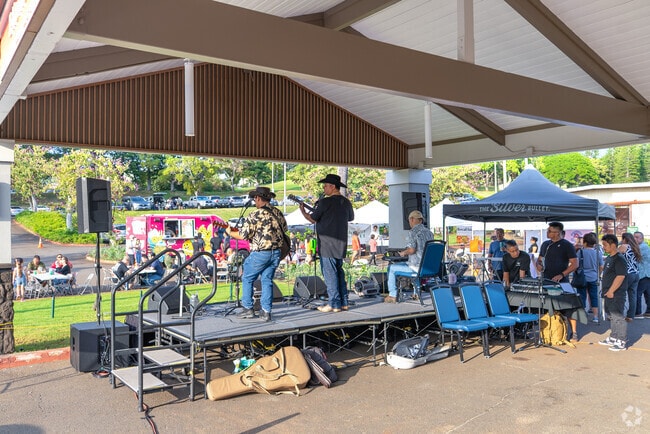 Local artists entertain guests at the night market in Kalauao.