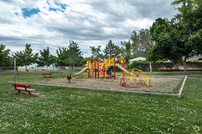 White flowers grow in the grass around St. Francis Xavier School’s colorful playground.