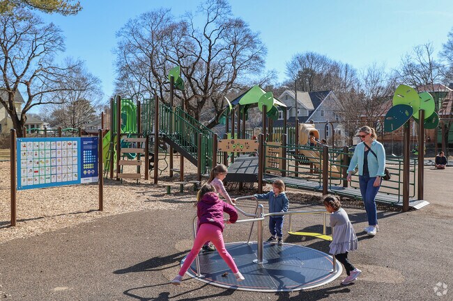 Take a spin on the bright playground at Warren Street Park near Greenwood.