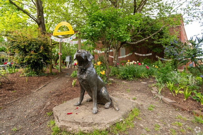 Dog sculpture in garden at Laurelhurst Elementary School.