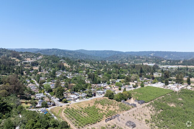 Corralitos homes nestle among trees and farms, surrounded by protected natural foothills.