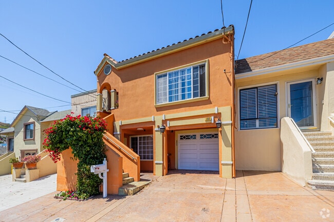 A cute orange Mediterranean-style home with a welcoming entrance in Bayshore.
