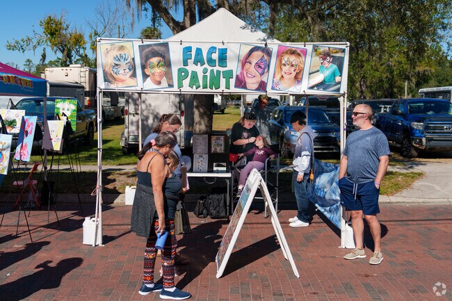 A young Longwood resident enjoys face painting at the Arts and Crafts Festival.