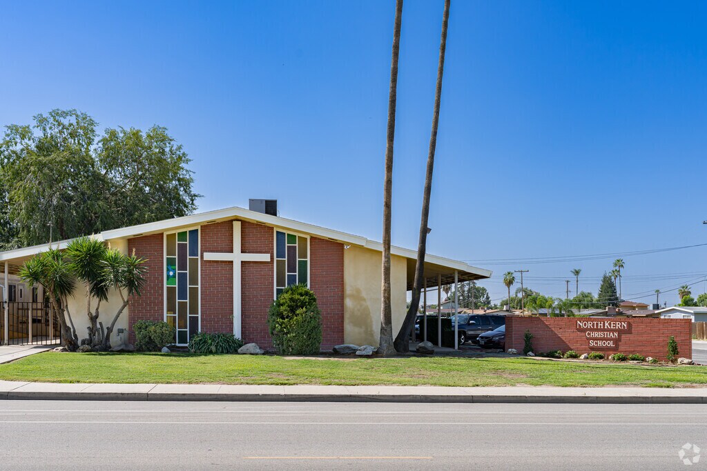Two large palm trees at the entrance to North Kern Christian in Wasco.